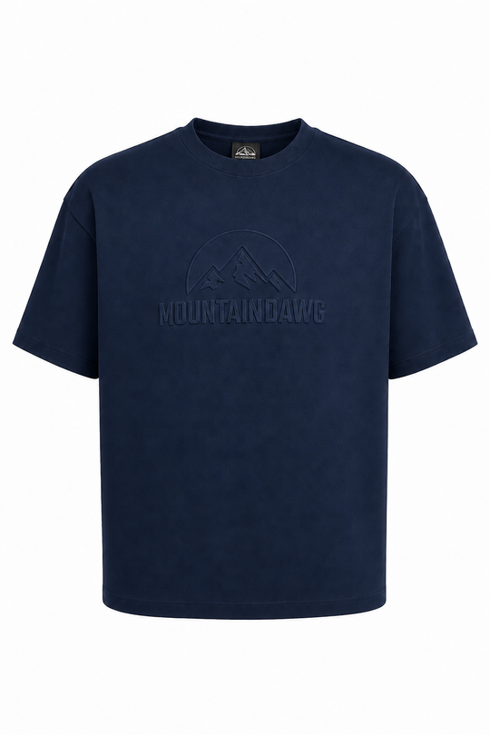 A dark navy blue short-sleeve crewneck t-shirt with a tonal dark logo on the chest featuring a mountain graphic and the brand name 'MOUNTAINDAWG'.