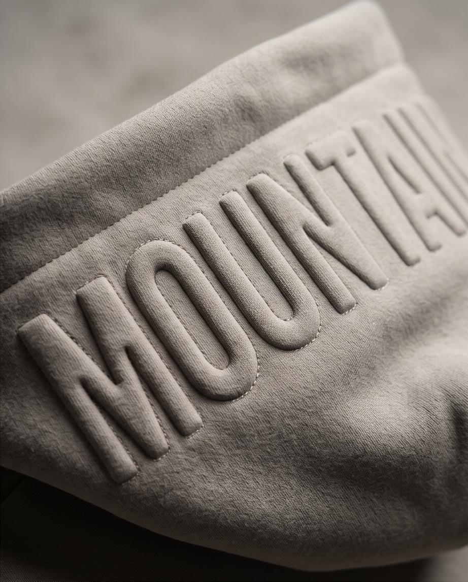 Gray fabric with 'MOUNTAIN DAWG' text embossed on it